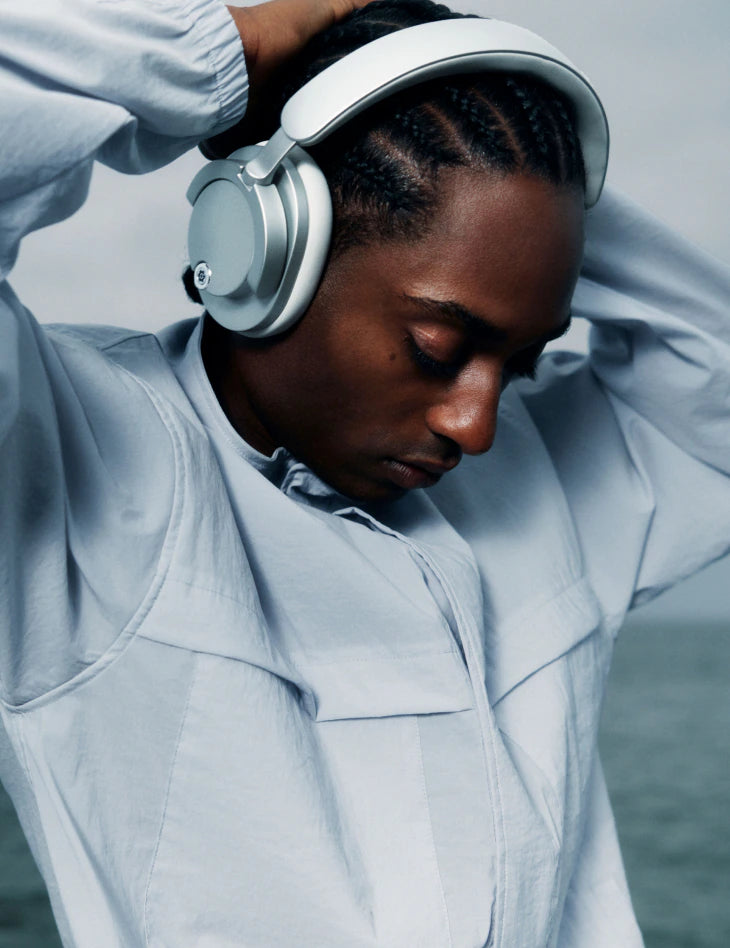 Person wearing Daisy One headphones by the ocean